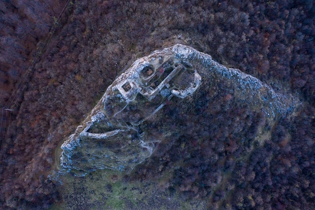 An aerial view of a geothermal power plant located near a Bitcoin mining facility. Steam rises from the geothermal plant, illustrating the use of renewable geothermal energy for powering the mining operation.